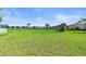 A sprawling backyard with lush green grass, waterfront views and a playset at 16768 San Edmundo Rd, Punta Gorda, FL 33955