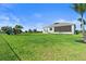 Expansive backyard featuring a well-maintained lawn, screened-in patio, and play structure at 16768 San Edmundo Rd, Punta Gorda, FL 33955