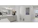Modern bathroom with sleek gray cabinetry, double vanity, elegant lighting, and marble look tile flooring at 16768 San Edmundo Rd, Punta Gorda, FL 33955
