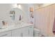 Bright bathroom featuring a white vanity, quartz countertop, and gold fixtures at 16768 San Edmundo Rd, Punta Gorda, FL 33955