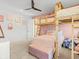 Cozy bedroom with a bunk bed and a light pink accent wall for a comfortable and playful atmosphere at 16768 San Edmundo Rd, Punta Gorda, FL 33955