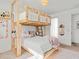 Comfortable bedroom featuring a natural wood bunk bed and modern decor for a cozy feel at 16768 San Edmundo Rd, Punta Gorda, FL 33955