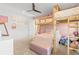 Charming bedroom with a loft bed, soft colors, and a playful ambiance at 16768 San Edmundo Rd, Punta Gorda, FL 33955