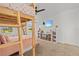 Bedroom with a fun loft bed setup, storage shelves, and a TV at 16768 San Edmundo Rd, Punta Gorda, FL 33955