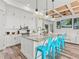 Modern kitchen with a large island, stylish blue bar stools, and a coffered ceiling at 16768 San Edmundo Rd, Punta Gorda, FL 33955