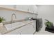 Laundry room features white cabinets and a modern front load washer and dryer at 16768 San Edmundo Rd, Punta Gorda, FL 33955