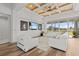 Bright living room features a wood-paneled ceiling, large sectional sofa, and expansive outdoor views at 16768 San Edmundo Rd, Punta Gorda, FL 33955