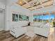 Stylish living room featuring wood floors, coffered ceilings, and large windows at 16768 San Edmundo Rd, Punta Gorda, FL 33955