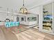 Open-concept living area featuring wood floors, coffered ceilings, and white modern furniture at 16768 San Edmundo Rd, Punta Gorda, FL 33955