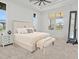 Bright main bedroom with natural light, tray ceilings, and a comfortable sitting area at 16768 San Edmundo Rd, Punta Gorda, FL 33955