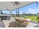 Covered patio with dining set and view of the water and lawn at 16768 San Edmundo Rd, Punta Gorda, FL 33955