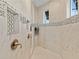 Luxurious walk-in shower featuring stylish tile work, modern fixtures, and a built-in shower niche at 16768 San Edmundo Rd, Punta Gorda, FL 33955