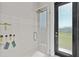 Beautiful tile shower with a rain shower head and glass door to backyard at 16768 San Edmundo Rd, Punta Gorda, FL 33955