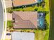 Aerial view of a private home with a screened-in pool and patio area overlooking a serene lake at 17916 Northwood Pl, Lakewood Ranch, FL 34202
