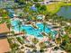 An aerial view of a luxurious resort-style pool surrounded by tropical landscaping and lounge areas at 17916 Northwood Pl, Lakewood Ranch, FL 34202