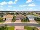 Aerial view of houses with well-manicured lawns and landscaping in a scenic community with lakes and ponds at 17916 Northwood Pl, Lakewood Ranch, FL 34202