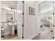 Stylish half bathroom featuring a pedestal sink, decorative mirror, hardwood floors, and neutral paint at 17916 Northwood Pl, Lakewood Ranch, FL 34202