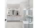 Bright bathroom features a double vanity, a makeup vanity and a glass-enclosed shower at 17916 Northwood Pl, Lakewood Ranch, FL 34202