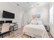 Comfortable bedroom showcasing natural light, a desk area, and soothing decor at 17916 Northwood Pl, Lakewood Ranch, FL 34202