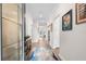 Bright hallway featuring hardwood floors, neutral walls, decorative art, and ample lighting at 17916 Northwood Pl, Lakewood Ranch, FL 34202