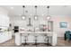 Modern kitchen with stainless steel appliances, a breakfast bar and decorative hanging pendant lights at 17916 Northwood Pl, Lakewood Ranch, FL 34202