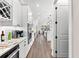 Gourmet kitchen features stainless appliances, quartz countertops, custom cabinets and wine storage; wood-look flooring throughout at 17916 Northwood Pl, Lakewood Ranch, FL 34202