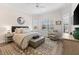 Bright main bedroom featuring a ceiling fan, large windows with shutters, and a stylish rug at 17916 Northwood Pl, Lakewood Ranch, FL 34202