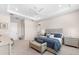 Spacious bedroom boasts neutral walls, carpeting, a ceiling fan, and an adjacent bathroom at 17916 Northwood Pl, Lakewood Ranch, FL 34202