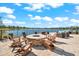 Inviting outdoor seating area with Adirondack chairs around a fire pit with lake views at 17916 Northwood Pl, Lakewood Ranch, FL 34202