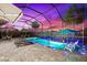 Beautiful screened pool area with pavers, loungers, and evening lighting at 17916 Northwood Pl, Lakewood Ranch, FL 34202
