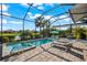 Screened pool area with brick pavers, in-ground pool, and lake view at 17916 Northwood Pl, Lakewood Ranch, FL 34202