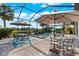 Screened pool area with outdoor dining and in-ground pool and spa at 17916 Northwood Pl, Lakewood Ranch, FL 34202