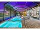 A luxurious screened pool and spa with dining and lounging areas provide the perfect outdoor retreat at 17916 Northwood Pl, Lakewood Ranch, FL 34202