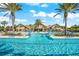 Stunning community pool area with cascading water features, palm trees, and ample seating at 17916 Northwood Pl, Lakewood Ranch, FL 34202