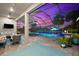 Screened pool area with outdoor furniture and landscaping at dusk at 17916 Northwood Pl, Lakewood Ranch, FL 34202