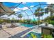 Inviting pool with chaise lounges, an umbrella and a covered seating area at 17916 Northwood Pl, Lakewood Ranch, FL 34202