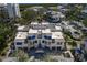 Aerial view of the multi-Gathering building showcases well-maintained grounds, a community pool, and beautiful landscaping at 1928 Harbourside Dr # 1403, Longboat Key, FL 34228