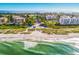 Breathtaking aerial view of Bay Isles Beach Club featuring the ocean, community, and lush greenery at 1928 Harbourside Dr # 1403, Longboat Key, FL 34228