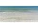 Expansive view of a sandy beach meeting tranquil turquoise waters at 1928 Harbourside Dr # 1403, Longboat Key, FL 34228