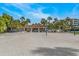 Picturesque beach volleyball court framed by lush greenery and palm trees, ideal for recreation at 1928 Harbourside Dr # 1403, Longboat Key, FL 34228