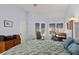 Spacious bedroom featuring soft blue walls, bright windows, and a white bed frame at 1928 Harbourside Dr # 1403, Longboat Key, FL 34228