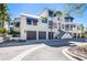 Charming condo exterior featuring a two-car garage, private entrance, with elegant architectural details and lush landscaping at 1928 Harbourside Dr # 1403, Longboat Key, FL 34228