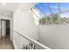 Bright hallway with large skylight and neutral walls leading to doorway, with views of the outdoor trees at 1928 Harbourside Dr # 1403, Longboat Key, FL 34228