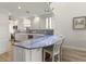 A kitchen with white cabinets, stainless appliances, and a blue tile backsplash at 1928 Harbourside Dr # 1403, Longboat Key, FL 34228