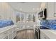 Sunlit kitchen nook with plantation shutters, hardwood floors, and modern appliances at 1928 Harbourside Dr # 1403, Longboat Key, FL 34228