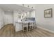 Charming kitchen with white cabinets, white chairs, a blue countertop and wood floor at 1928 Harbourside Dr # 1403, Longboat Key, FL 34228