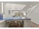 Bright, open-concept living space with skylight, stairs, and island with seating at 1928 Harbourside Dr # 1403, Longboat Key, FL 34228