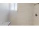A sleek shower space featuring light-colored tile and a frosted glass partition in a modern bathroom at 1928 Harbourside Dr # 1403, Longboat Key, FL 34228