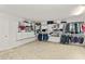Large walk-in closet with ample built-in shelving, rods, and storage drawers for organized living at 1928 Harbourside Dr # 1403, Longboat Key, FL 34228