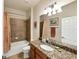 Bathroom featuring tub-shower combo, granite vanity and sink, and neutral tiling at 19993 Benissimo Dr, Venice, FL 34293